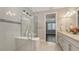 Bathroom featuring large glass shower, double vanity, and neutral decor at 1481 Hyssop Loop, North Port, FL 34289