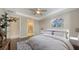 Bright bedroom with tray ceiling, ceiling fan, ensuite bath, and neutral decor at 1481 Hyssop Loop, North Port, FL 34289