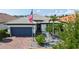 Charming single-story home featuring a manicured lawn, paver driveway, and neutral paint scheme at 1481 Hyssop Loop, North Port, FL 34289