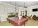 Inviting game room featuring a pool table, card tables, and ample seating for residents' enjoyment at 1481 Hyssop Loop, North Port, FL 34289