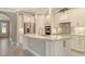 Modern kitchen with stainless steel appliances, granite countertops, and ample cabinet space at 1481 Hyssop Loop, North Port, FL 34289