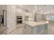 Spacious kitchen with a large island, white cabinets, stainless steel appliances, and pendant lighting at 1481 Hyssop Loop, North Port, FL 34289