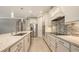 Bright, modern kitchen featuring white cabinetry, stainless steel appliances, and a stylish backsplash at 1481 Hyssop Loop, North Port, FL 34289