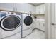 Bright laundry room featuring appliances, lots of storage, and sink at 1481 Hyssop Loop, North Port, FL 34289