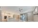 Open-concept living space with stainless appliances and outdoor views through sliding glass doors at 1481 Hyssop Loop, North Port, FL 34289