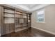 Home office with custom wooden built-in shelving and storage at 1481 Hyssop Loop, North Port, FL 34289