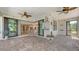 Covered patio features brick flooring, ceiling fans, and a view into the home's kitchen at 1481 Hyssop Loop, North Port, FL 34289