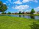 Scenic view of the community pond surrounded by lush greenery and well-maintained lawns at 1493 Maseno Dr, Venice, FL 34292