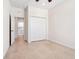Bright bedroom featuring tile floors, a ceiling fan, closet space, and a door that leads to a bathroom and laundry area at 1493 Maseno Dr, Venice, FL 34292