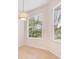 Bright breakfast nook with natural light from large windows, featuring serene outdoor views at 1493 Maseno Dr, Venice, FL 34292