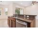Functional kitchen area with a breakfast bar, stainless steel appliances, and ample counter space at 1493 Maseno Dr, Venice, FL 34292