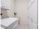 Laundry room with washer and dryer and storage with white cabinets for organizing essentials at 1493 Maseno Dr, Venice, FL 34292