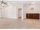 Open-concept living room with tile flooring, ceiling fan, and dark wood built-in cabinet at 1493 Maseno Dr, Venice, FL 34292