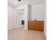 Open living space featuring tile flooring and a wooden cabinet for storage at 1493 Maseno Dr, Venice, FL 34292