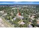Aerial view showcases home's location near wooded areas and community amenities under a bright sky at 1515 Pecan St, Nokomis, FL 34275
