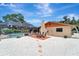 Backyard view with patio, outside dining area, and pool with enclosure at 1515 Pecan St, Nokomis, FL 34275