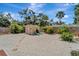 Backyard and shed with rock ground cover, landscaping, and lounge chairs at 1515 Pecan St, Nokomis, FL 34275