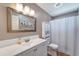 Cozy bathroom with a white vanity, large mirror, cabinet, and shower with a curtain at 1515 Pecan St, Nokomis, FL 34275