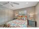 Cozy bedroom with dual windows, colorful bedding, and ample closet space at 1515 Pecan St, Nokomis, FL 34275