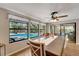 Bright dining room with a pool view, ceiling fan, and a long dining table at 1515 Pecan St, Nokomis, FL 34275