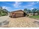 View of home exterior, garage, and driveway at 1515 Pecan St, Nokomis, FL 34275