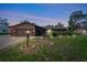 Charming single-story brick home with a well-manicured lawn and inviting curb appeal at twilight at 1515 Pecan St, Nokomis, FL 34275