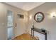 Bright foyer featuring a decorative front door, stylish mirror, and elegant console table at 1515 Pecan St, Nokomis, FL 34275