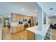 Well-appointed kitchen with modern appliances, light wood cabinetry, and a breakfast bar at 1515 Pecan St, Nokomis, FL 34275