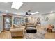 Open living space with a comfortable sectional sofa, bay window, and access to the foyer at 1515 Pecan St, Nokomis, FL 34275