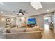 Bright living room with a large TV, comfortable sofa, and stylish decor at 1515 Pecan St, Nokomis, FL 34275