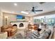 Welcoming living room with fireplace, wood floors, comfortable seating, and view to dining area at 1515 Pecan St, Nokomis, FL 34275