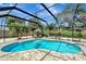 View of the pool surrounded by a screened enclosure and brick patio at 1515 Pecan St, Nokomis, FL 34275