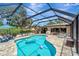 Beautiful screened-in pool with patio and lounge seating area at 1515 Pecan St, Nokomis, FL 34275
