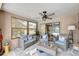 Bright sunroom with comfortable seating, a ceiling fan, and sliding glass doors that lead to the pool area at 1515 Pecan St, Nokomis, FL 34275