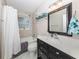 Elegant bathroom featuring a vanity with ample counter space, tub, and shower with a curtain at 161 Suntan Ave, Sarasota, FL 34237