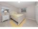 Serene bedroom featuring a white bed frame, side table, and two sunny windows at 161 Suntan Ave, Sarasota, FL 34237