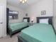 Comfortable bedroom features two twin beds, tasteful decor, and a serene atmosphere at 161 Suntan Ave, Sarasota, FL 34237