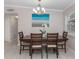 Bright dining room with wooden table set, modern chandelier, and decorative wall art at 161 Suntan Ave, Sarasota, FL 34237
