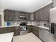 Well-equipped kitchen features stainless appliances, stylish cabinets, and quartz countertops at 161 Suntan Ave, Sarasota, FL 34237