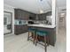 Stylish kitchen featuring gray cabinets, stainless steel appliances, and a center island at 161 Suntan Ave, Sarasota, FL 34237