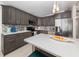 Modern kitchen with stainless steel appliances, gray cabinetry, and quartz countertops at 161 Suntan Ave, Sarasota, FL 34237