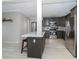 Kitchen with stainless steel appliances, breakfast bar, and gray cabinetry at 161 Suntan Ave, Sarasota, FL 34237