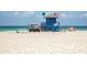 Beach view featuring a lifeguard tower, soft sand, and clear skies offering a relaxing coastal lifestyle at 161 Suntan Ave, Sarasota, FL 34237