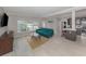 Open-concept living room with modern couch, windows and view of kitchen at 161 Suntan Ave, Sarasota, FL 34237