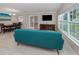 Open-concept living room with a modern couch, large windows, and wood-look floors at 161 Suntan Ave, Sarasota, FL 34237