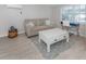Bright living room with a comfortable couch, area rug, and light colored floors at 161 Suntan Ave, Sarasota, FL 34237