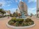 Aesthetic urban roundabout featuring an abstract sculpture, surrounded by lush greenery and buildings at 161 Suntan Ave, Sarasota, FL 34237