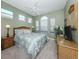 Comfortable bedroom with vaulted ceiling, wicker furniture and natural light, ideal for restful nights at 165 Tiziano Way, North Venice, FL 34275