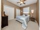 Inviting bedroom with a ceiling fan, neutral tones, and ample closet space, ideal for relaxation at 165 Tiziano Way, North Venice, FL 34275