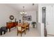 Cozy dining room features a wood table, decorative chandelier, and complementing wood cabinet at 165 Tiziano Way, North Venice, FL 34275